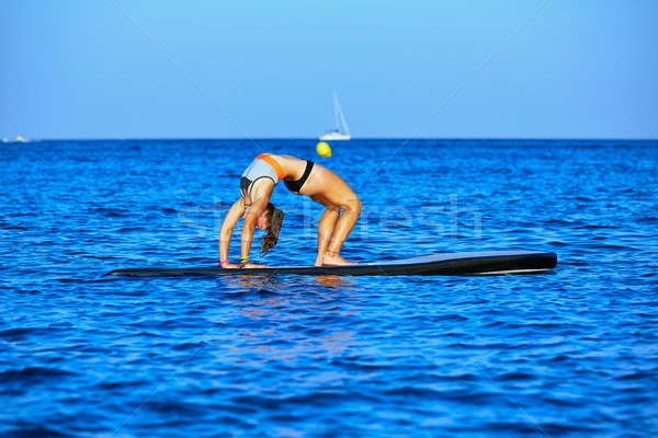 Yoga girl over SUP Stand up Surf board Stock photo © lunamarina