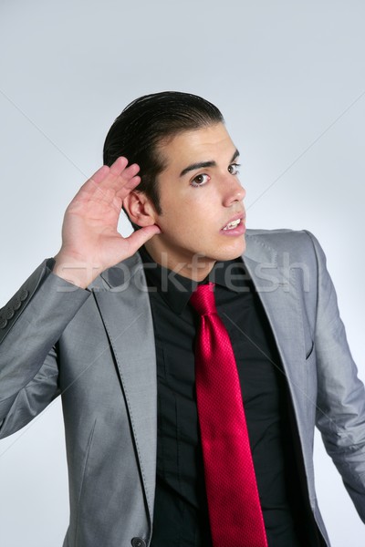 Businessman with hand in ear as a deafness sign Stock photo © lunamarina