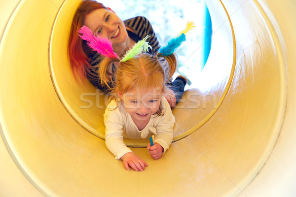 Kid girl and mother playing in the park slider Stock photo © lunamarina