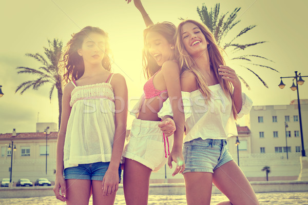 Stock photo: Best friends teen girls fun in a beach sunset