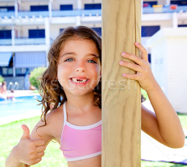 indented kid girl ok gesture in pool garden Stock photo © lunamarina