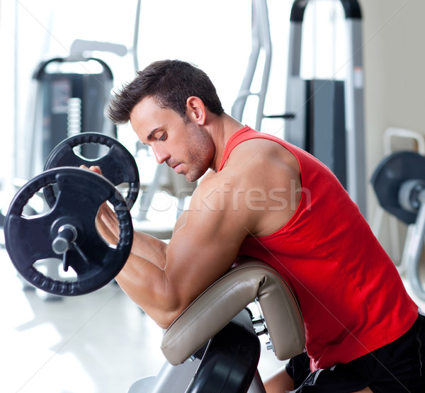 man with weight training equipment on sport gym Stock photo © lunamarina