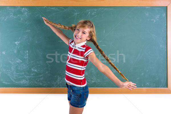 Braided student blond girl playing with braids Stock photo © lunamarina