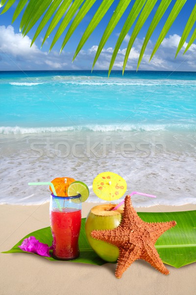 Stock photo: coconut red cocktail with starfish in tropical beach