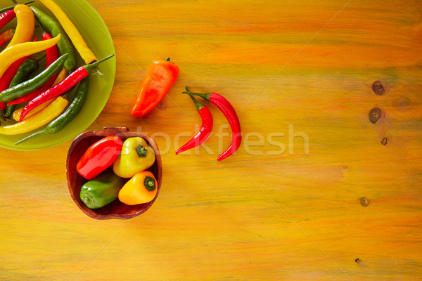 Colorful mexican chili peppers in yellow Stock photo © lunamarina