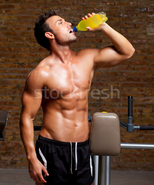  muscle man at gym relaxed with energy drink Stock photo © lunamarina