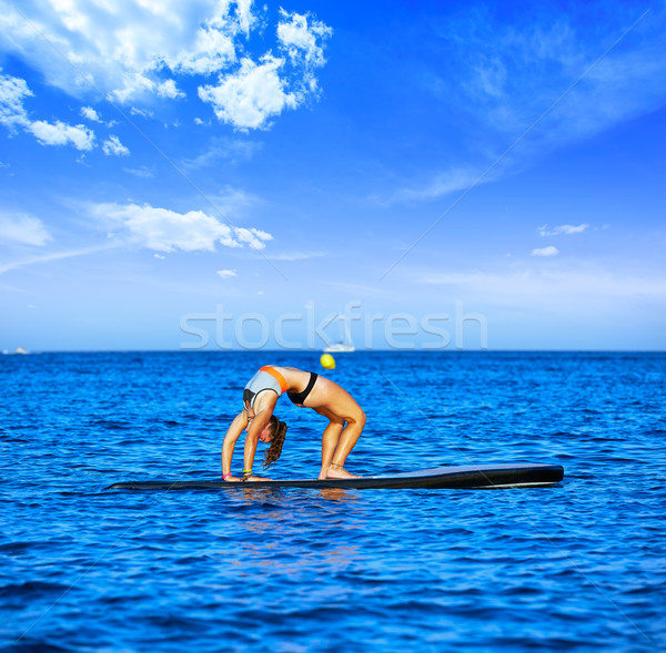 Yoga girl over SUP Stand up Surf board Stock photo © lunamarina