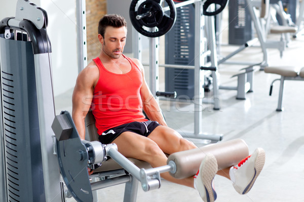 man lifting weights with a leg press on sport gym Stock photo © lunamarina