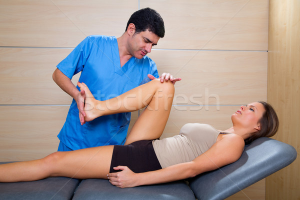 hip mobilization therapy by physiotherapist to woman patient Stock photo © lunamarina