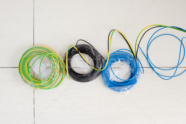Electric cable coil in three colors black blue and earth Stock photo © lunamarina