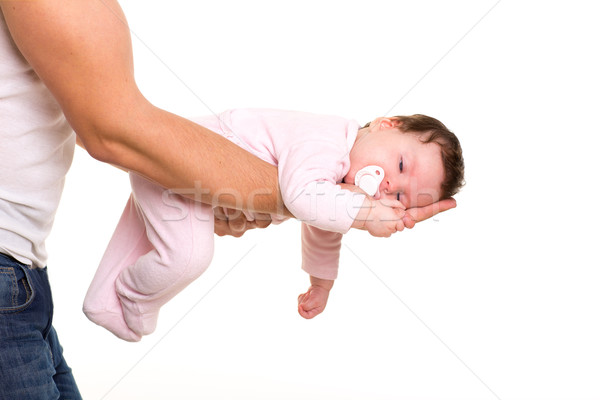 almost sleeping baby girl in father arms on white Stock photo © lunamarina