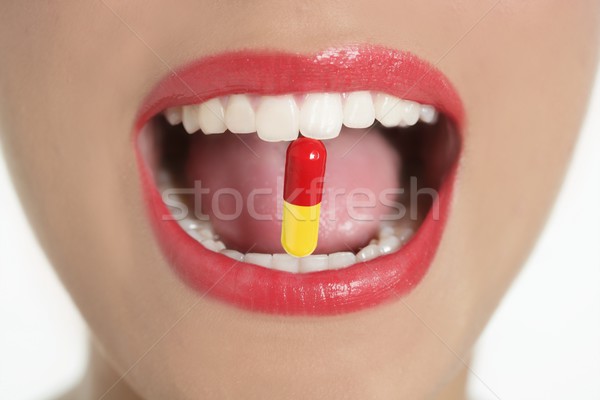 Beleza mulher boca medicina pílula lábios vermelhos Foto stock © lunamarina