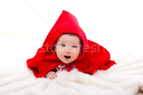 Baby Little Red Riding Hood on white fur Stock photo © lunamarina