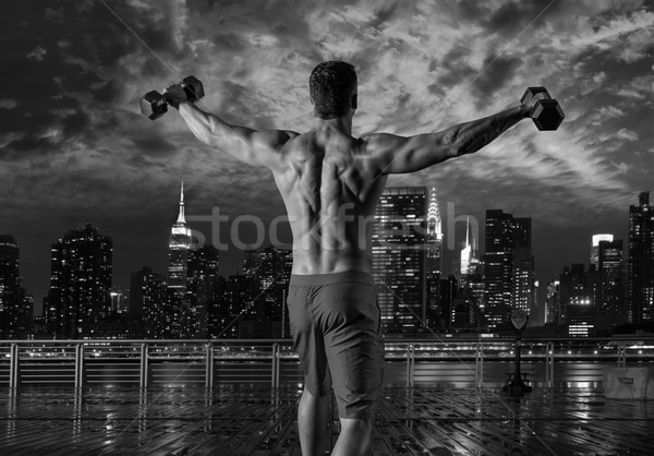 gym man rising hex dumbbells in New York city Stock photo © lunamarina