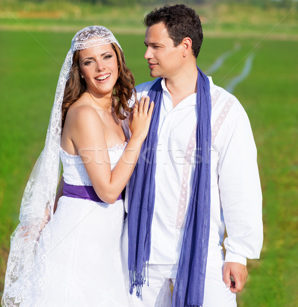 Couple in wedding day hug in green meadow Stock photo © lunamarina