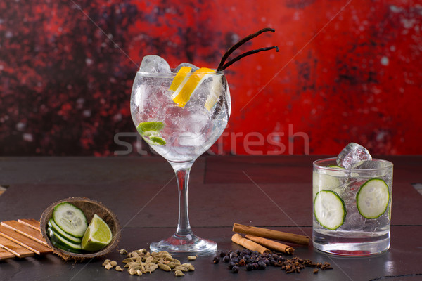 Gin tonic cocktail with spices in red grunge background Stock photo © lunamarina