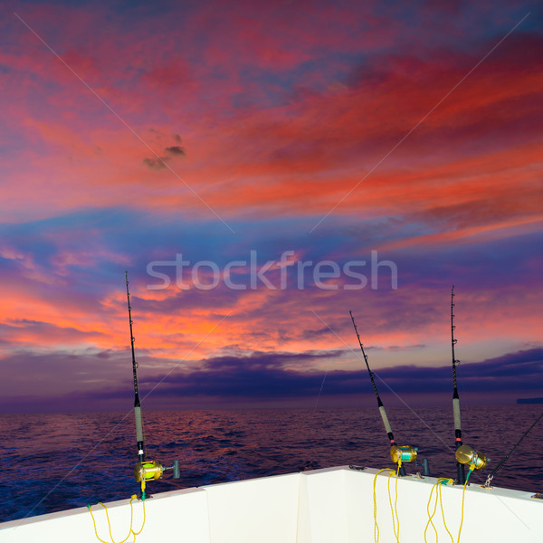 boat fishing trolling at sunset with rods and reels Stock photo © lunamarina
