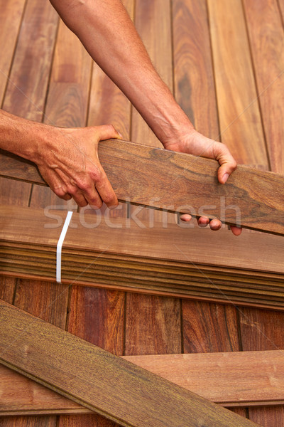 Ipe deck installation carpenter hands holding wood Stock photo © lunamarina