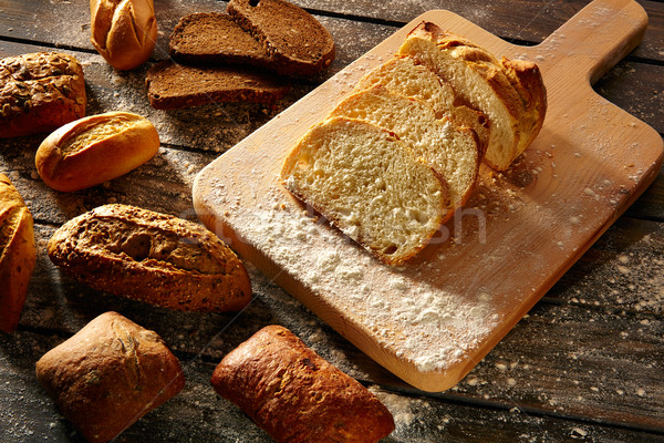 Bread varied loafs sliced on wood board in rustic Stock photo © lunamarina