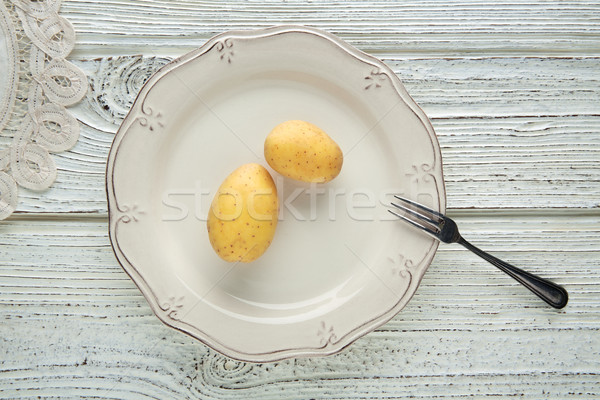 potatoes in white plate minimalist food concept Stock photo © lunamarina