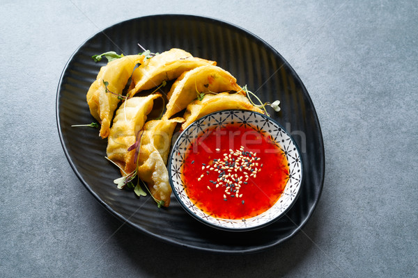 Steamed gyozas teriyaki sauce and sesame Stock photo © lunamarina