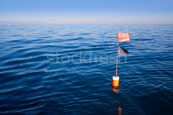 Longliner and trammel net buoy with flag pole Stock photo © lunamarina