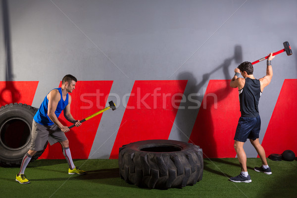 Sledgehammer Tire Hits men workout at gym Stock photo © lunamarina