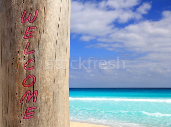 Caribbean beach spell welcome written in pole Stock photo © lunamarina