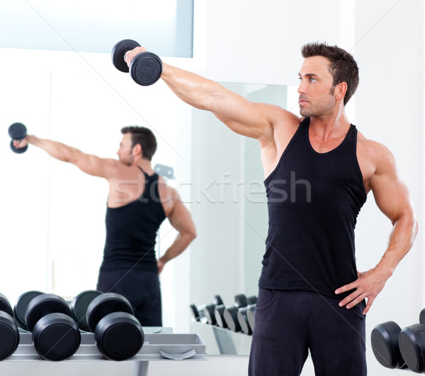 Stock photo:  man with weight training equipment on sport gym