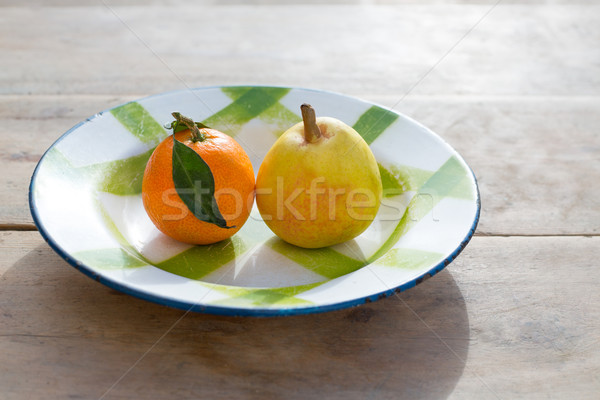 fruits tangerine and pear in vintage porcelain dish plate Stock photo © lunamarina