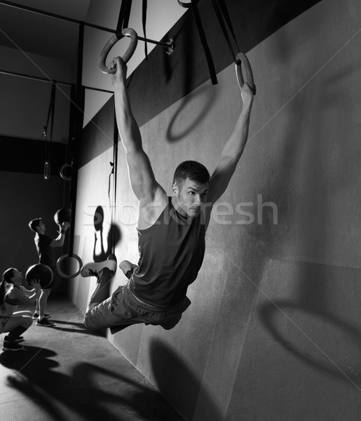 Stock photo: Muscle ups rings man swinging workout at gym