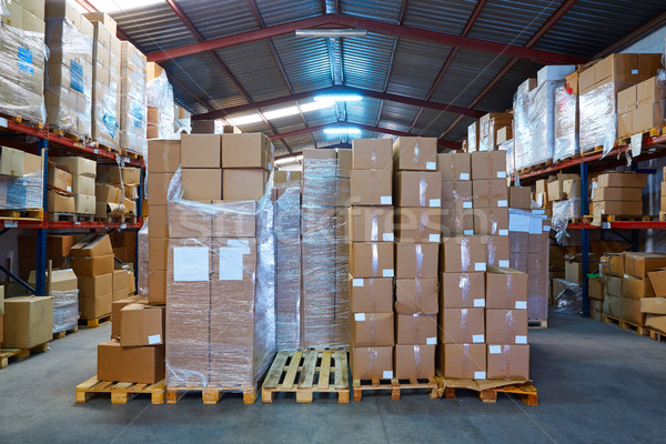 Warehouse stograge with stacked boxes in rows Stock photo © lunamarina