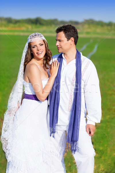 Couple in wedding day hug in green meadow Stock photo © lunamarina