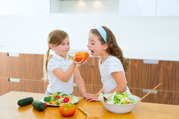 Stock photo: Beautiful chef sisters at home kitchen preparing salad