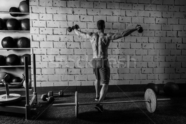 Stock photo: gym man rising hex dumbbells weightlifting rear