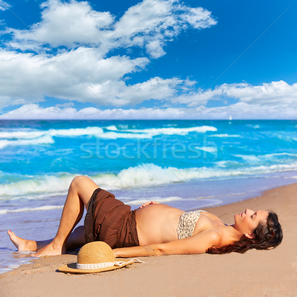 Beautiful pregnant woman on the beach Stock photo © lunamarina