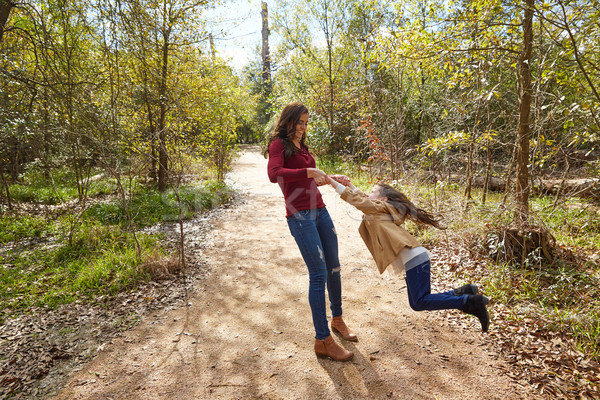 Stock photo: Mother and daughter being spun in circles