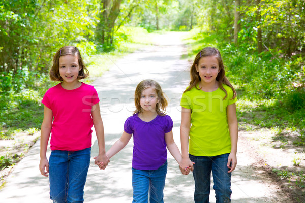 Friends and sister girls walking outdoor in forest track Stock photo © lunamarina