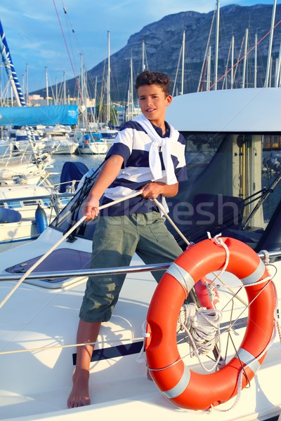 Boy teen sailor mooring boat rope in harbor Stock photo © lunamarina