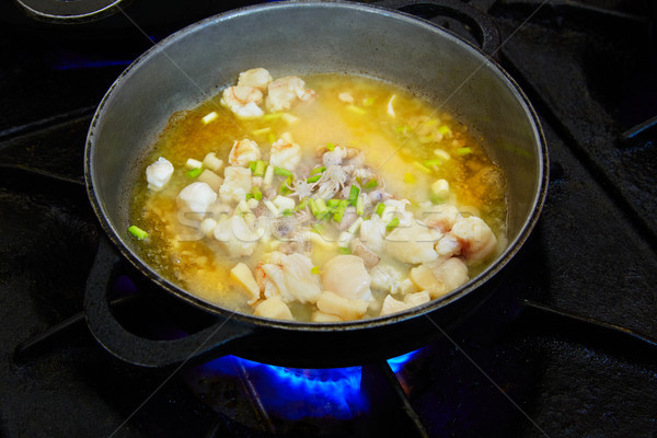 Seafood paella cooking process with squid Stock photo © lunamarina