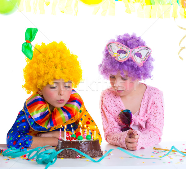 Children birthday party clown wigs blowing cake candles Stock photo © lunamarina