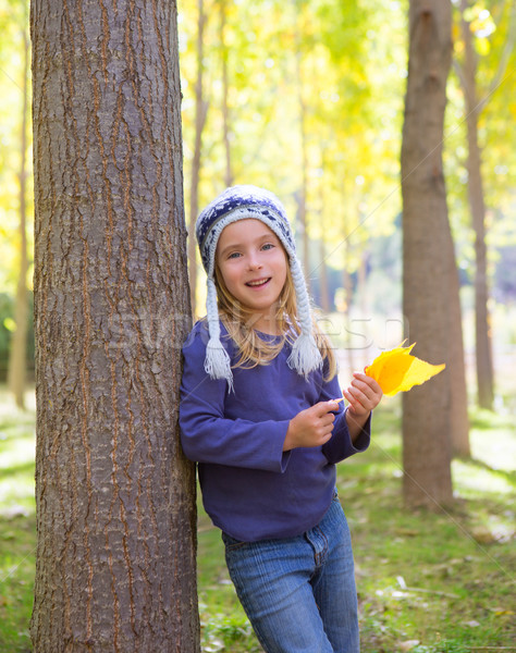 Child girl in autumn poplar forest yellow fall leaves in hand Stock photo © lunamarina