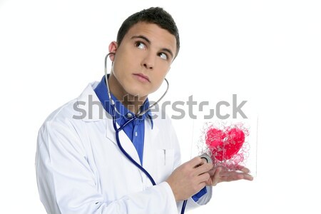 Doctor test a red heart health, young man Stock photo © lunamarina