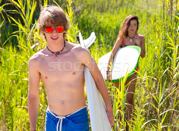 Stock photo: Surfer boy and girl walking in the green jungle