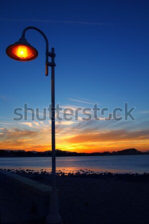 Sunset orange blue seascape light lamppost Stock photo © lunamarina