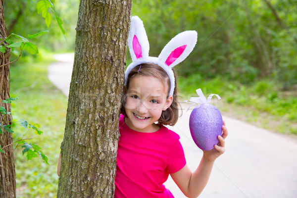 Easter girl with big purple egg and funny bunny ears Stock photo © lunamarina