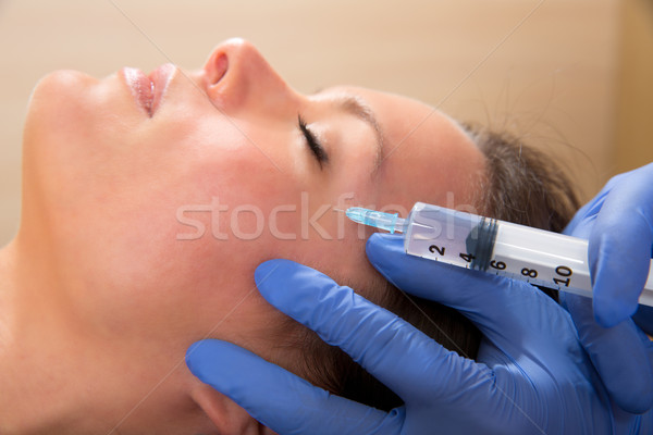 Anti aging facial mesotherapy syringe on woman face Stock photo © lunamarina