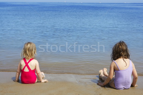 tow sisters sit on beach bathing suit swimsuit Stock photo © lunamarina