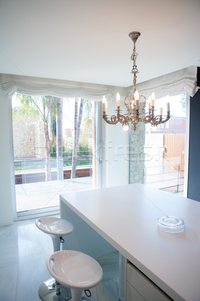 Modern white kitchen table with vintage chandelier Stock photo © lunamarina