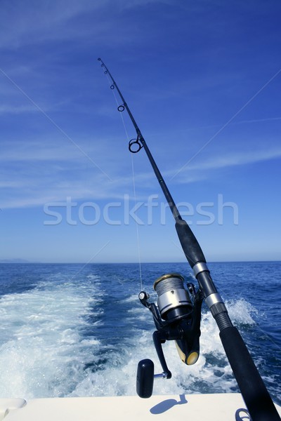 Stock photo: Fishing rod and reel on boat, fishing in blue ocean
